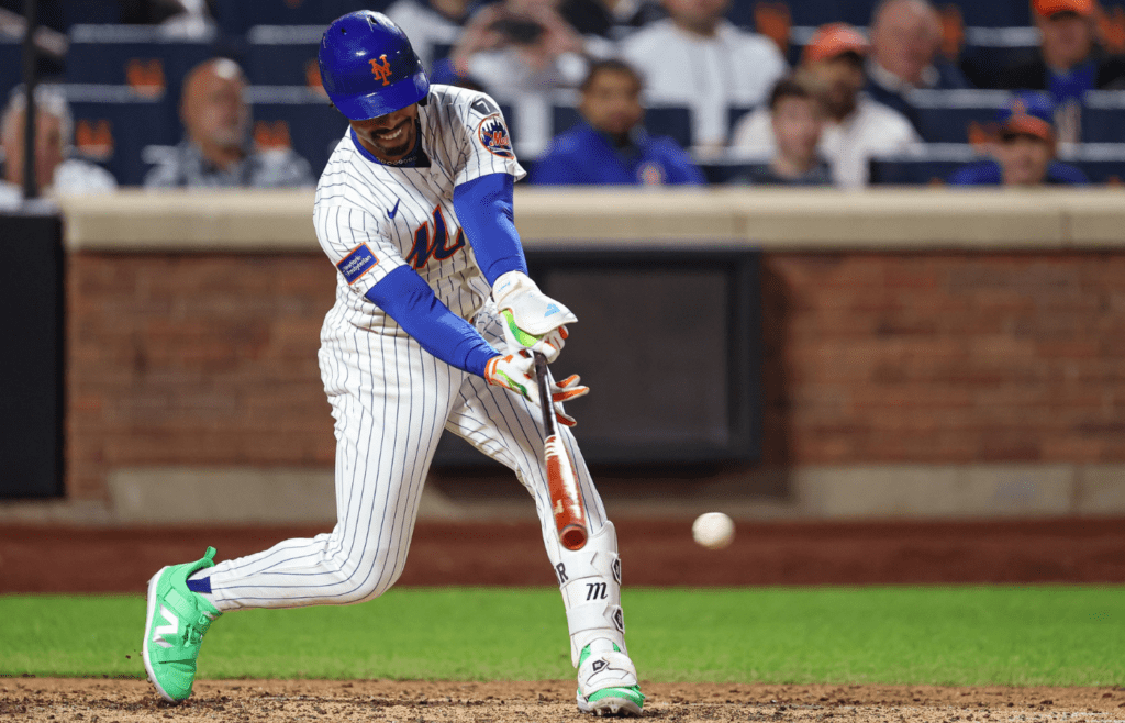 May 27, 2025; New York City, New York, USA; New York Mets shortstop Francisco Lindor (12) hits a two RBI single during the eighth inning against the Chicago White Sox at Citi Field. Mandatory Credit: Vincent Carchietta-Imagn Images
