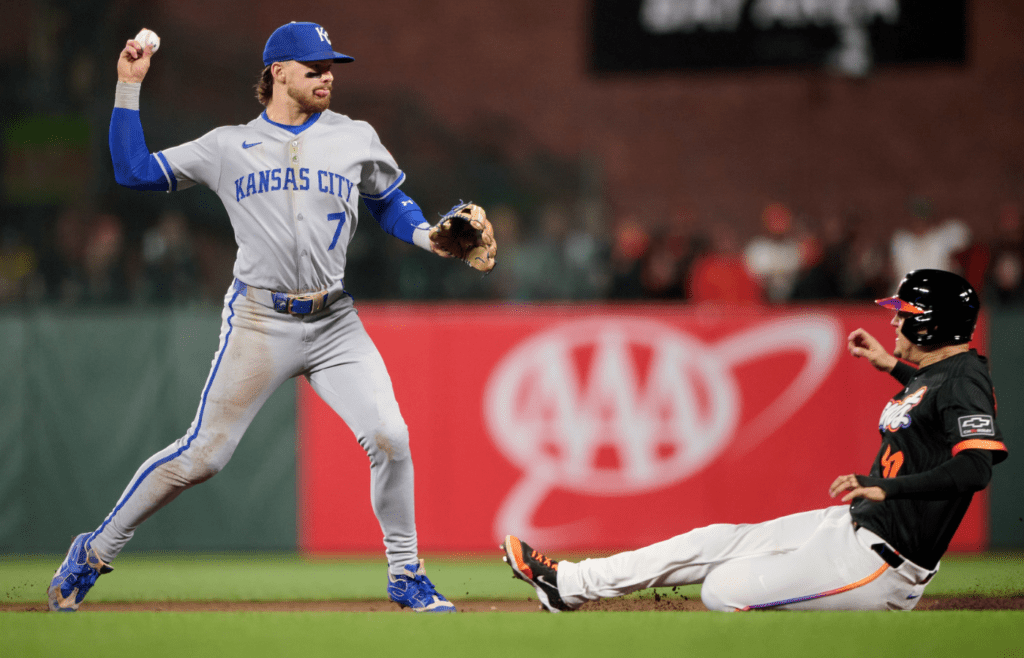 May 20, 2025; San Francisco, California, USA; Kansas City Royals shortstop Bobby Witt Jr. (7) turns a double play against San Francisco Giants first baseman Wilmer Flores (41) during the seventh inning at Oracle Park. Mandatory Credit: Robert Edwards-Imagn Images