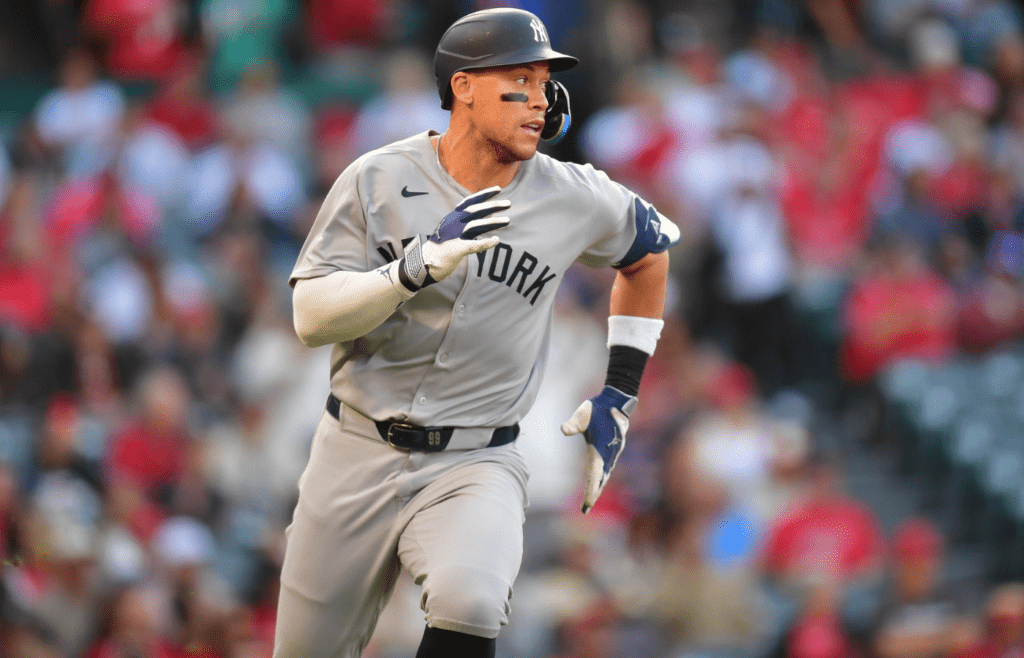 May 27, 2025; Anaheim, California, USA; New York Yankees right fielder Aaron Judge (99) runs after hitting a single against the Los Angeles Angels during the first inning at Angel Stadium. Mandatory Credit: Gary A. Vasquez-Imagn Images