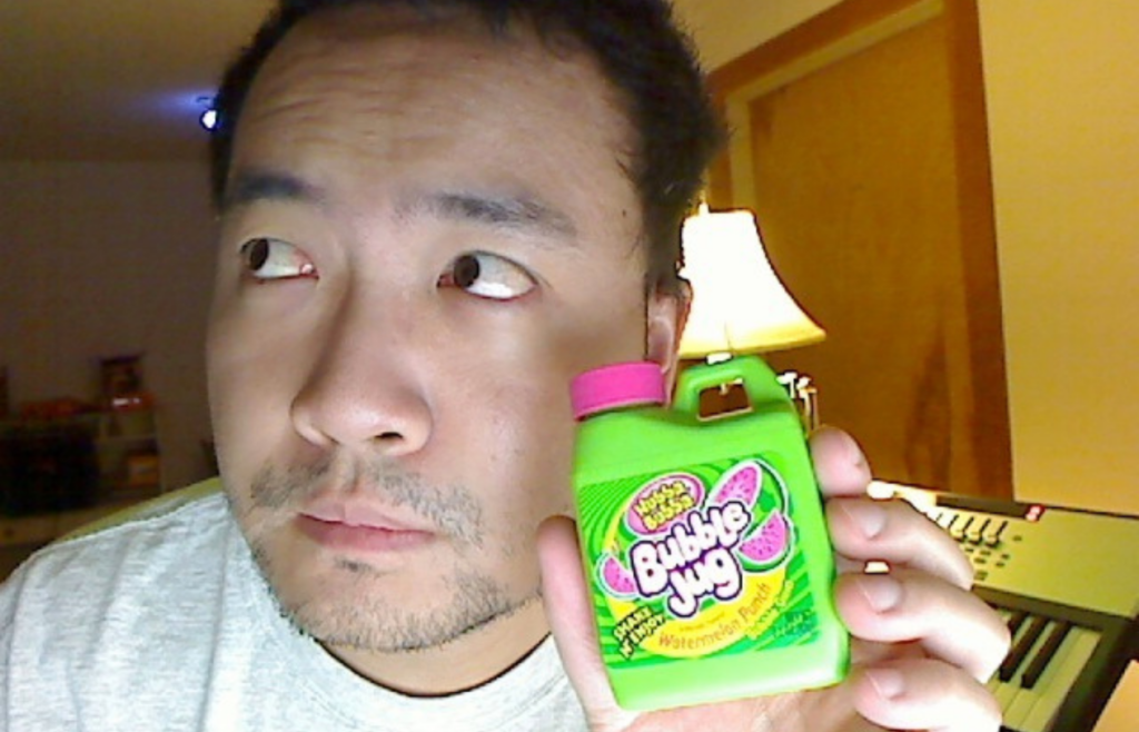 Man holding a green Bubble Jug candy