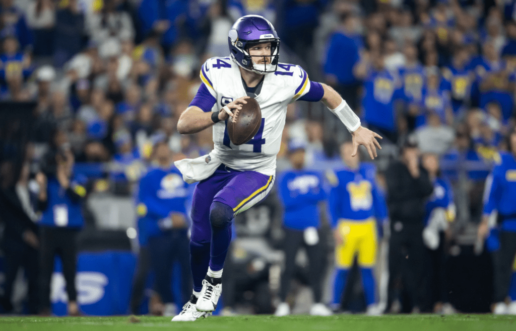 Jan 13, 2025; Glendale, AZ, USA; Minnesota Vikings quarterback Sam Darnold (14) against the Los Angeles Rams during an NFC wild card game at State Farm Stadium. Mandatory Credit: Mark J. Rebilas-Imagn Images