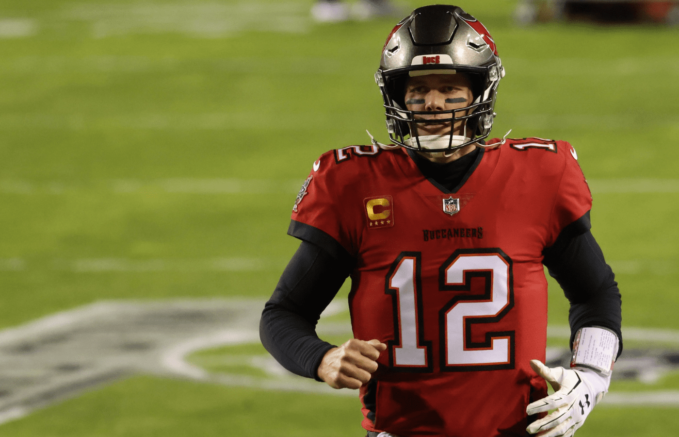Jan 9, 2021; Landover, Maryland, USA; Tampa Bay Buccaneers quarterback Tom Brady (12) runs onto the field for warmups prior to the Buccaneers' game against the Washington Football Team at FedExField. Mandatory Credit: Geoff Burke-Imagn Images