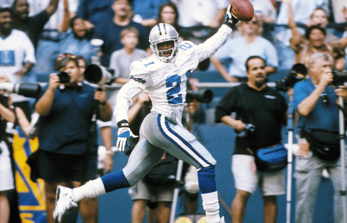 Sep 11, 1997; Irving, TX, USA; FILE PHOTO: Dallas Cowboys defensive back Deion Sanders (21) celebrating as he scores a touchdown on an interception against the Chicago Bears at Texas Stadium. Mandatory Credit: James D. Smith-Imagn Images