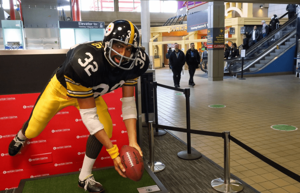 While the airport's iconic Franco Harris statue may be temporarily displaced, visitors can still visit the tribute to the Steelers player inside the landside terminal under the ticketing center. Pit Terminal Update March 2023 01