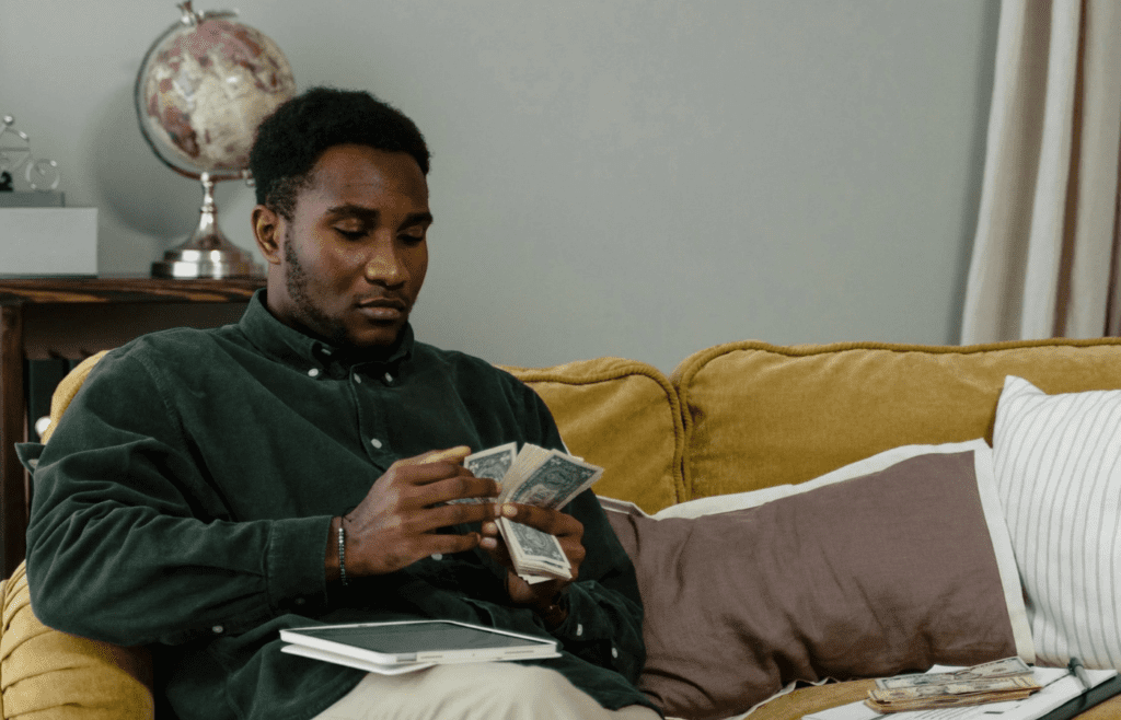Person counting money to allocate for savings