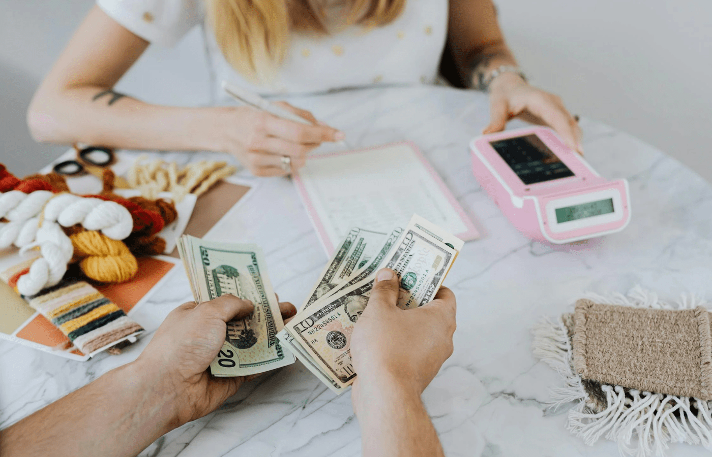 Budgeting money beside digital savings device