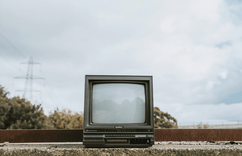 Retro TV set placed on stone surface