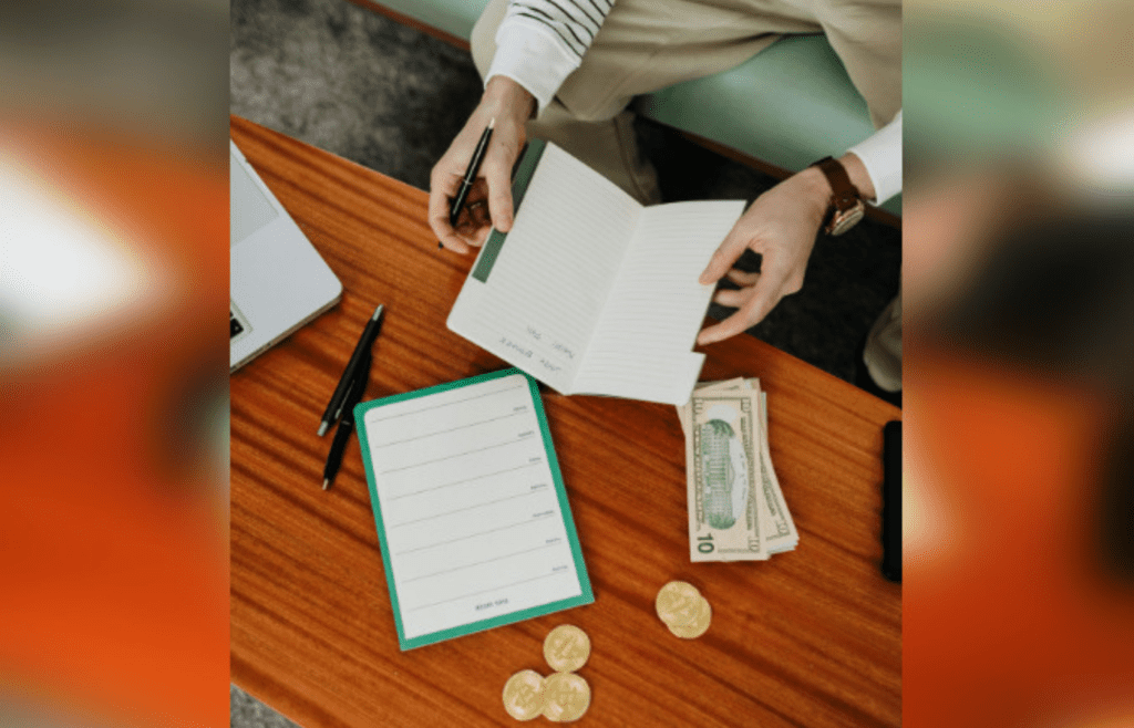 Financial planning with notebook, currency, and laptop