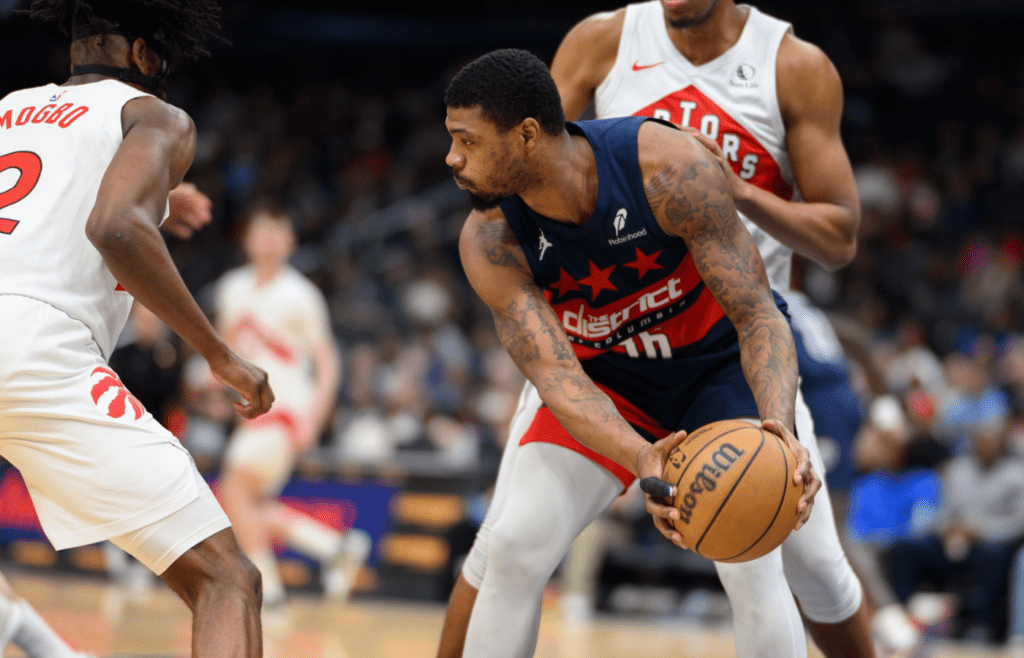 Mar 24, 2025; Washington, District of Columbia, USA; Washington Wizards guard Marcus Smart (36) rebounds the ball during the third quarter against Toronto Raptors forward Jonathan Mogbo (2) at Capital One Arena. Mandatory Credit: Reggie Hildred-Imagn Images