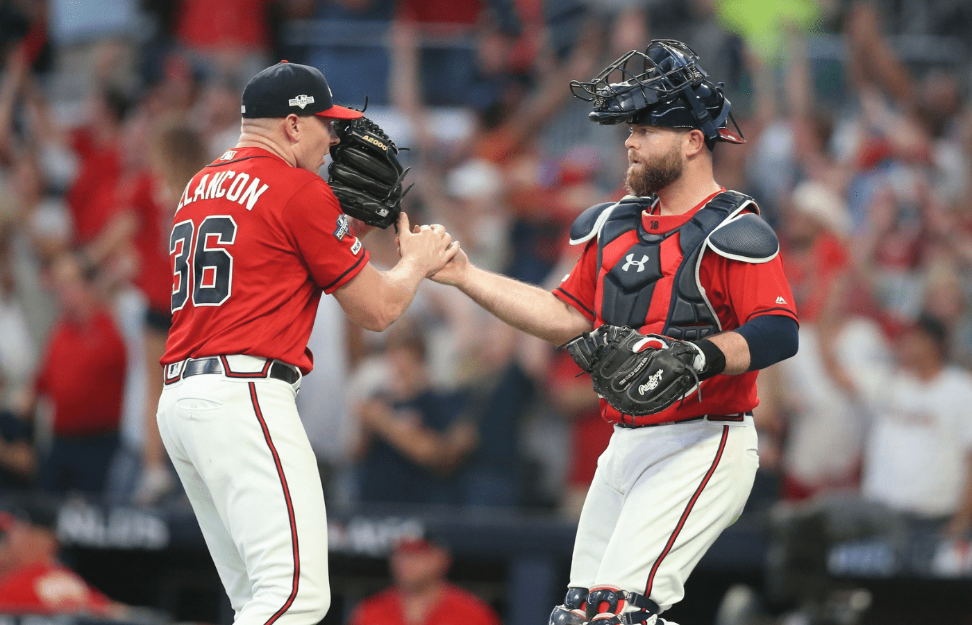 Oct 4, 2019; Atlanta, GA, USA; Atlanta Braves relief pitcher Mark Melancon (36) celebrates with catcher Brian McCann (16) after defeating the St. Louis Cardinals in game two of the 2019 NLDS playoff baseball series at SunTrust Park. Mandatory Credit: Brett Davis-Imagn Images