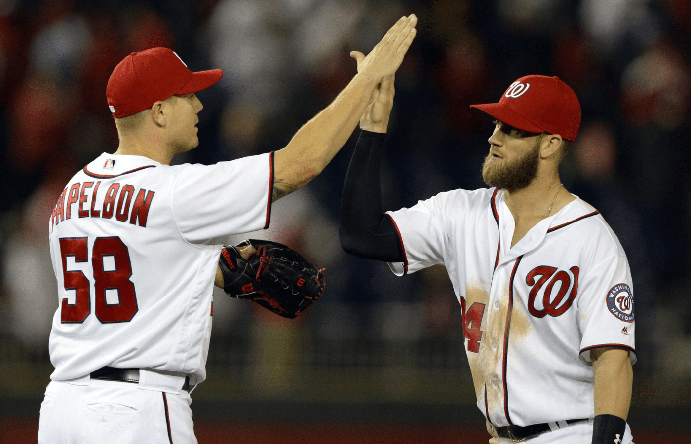 Apr 11, 2016; Washington, DC, USA; Washington Nationals relief pitcher Jonathan Papelbon (58) and right fielder Bryce Harper (34) celebrate on the field after defeating Atlanta Braves 6-4 at Nationals Park. Mandatory Credit: Tommy Gilligan-Imagn Images