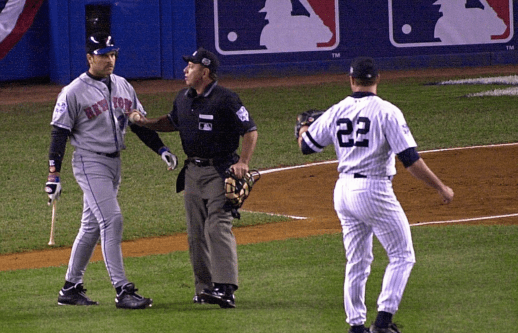Oct 22, 2000; New York, NY, USA; Mike Piazza confronts Roger Clemens as home plate umpire Charlie Reliford separates the two. Clemens threw the shattered bat back to Piazza in the first inning. The Yankees played the Mets in game two of the Subway Series at Yankee Stadium in the Bronx. Mandatory Credit: Joe Larese/The Journal News-USA TODAY NETWORK