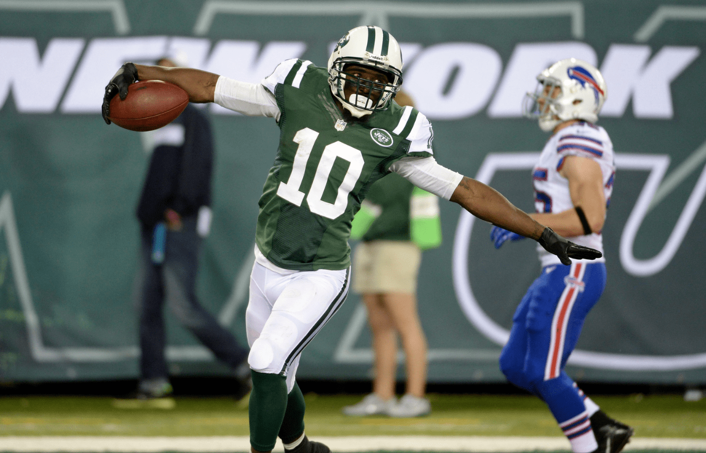 Sep 22, 2013; East Rutherford, NJ, USA; New York Jets wide receiver Santonio Holmes (10) scores a touchdown in the fourth quarter against the Buffalo Bills at MetLife Stadium. Mandatory Credit: Robert Deutsch-Imagn Images