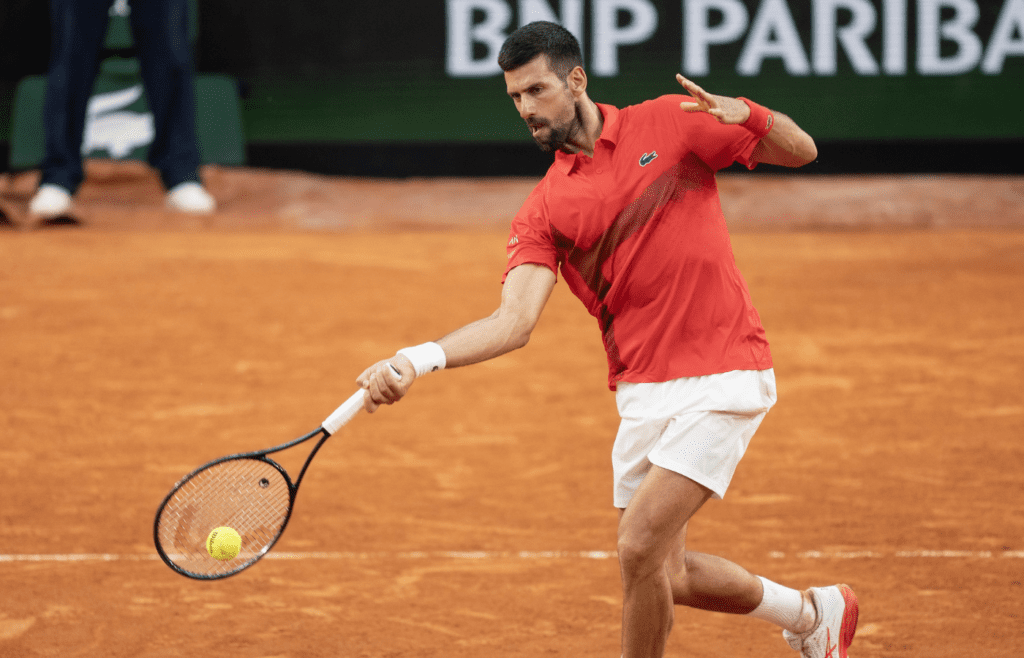 May 29, 2025; Paris, FR; Novak Djokovic of Serbia returns a shot during his match against Corentin Moutet of France on day five at Roland Garros Stadium. Mandatory Credit: Susan Mullane-Imagn Images
