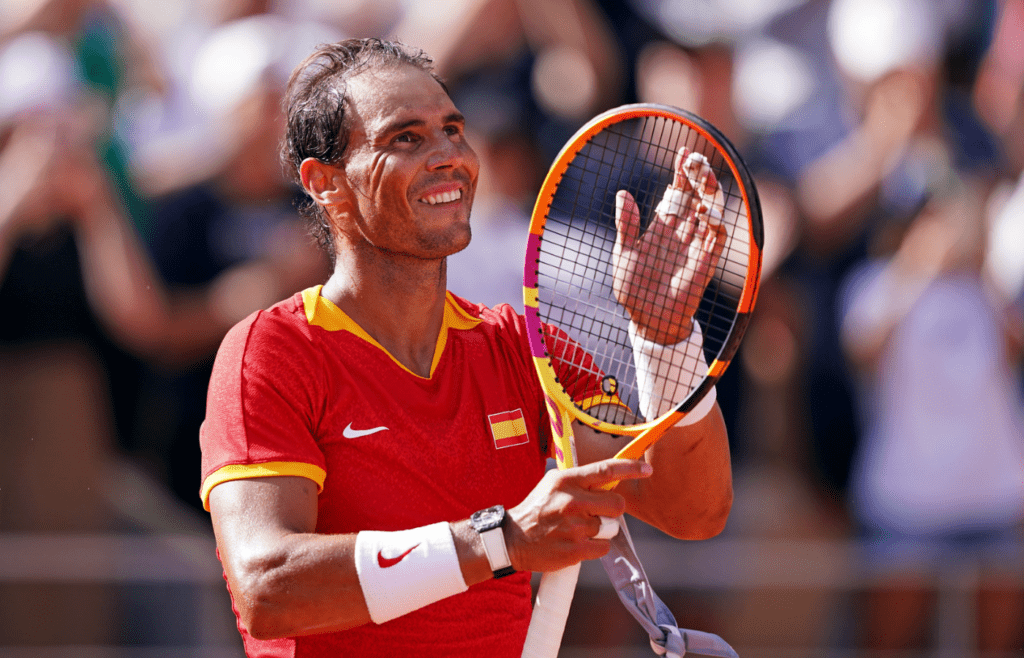 Jul 28, 2024; Paris, France; Rafael Nadal (ESP) celebrates after his match against Marton Fucsovics (HUN) in the men’s tennis singles first round during the Paris 2024 Olympic Summer Games at Stade Roland Garros. Mandatory Credit: Amber Searls-Imagn Images