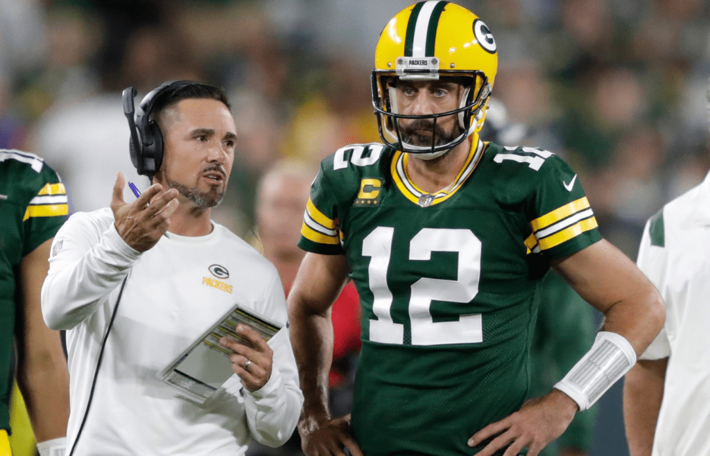 Green Bay Packers head coach Matt LaFleur talks with quarterback Aaron Rodgers (12) in between quarters against the Chicago Bears during their game on Sep 18, 2022, in Green Bay, Wisconsin