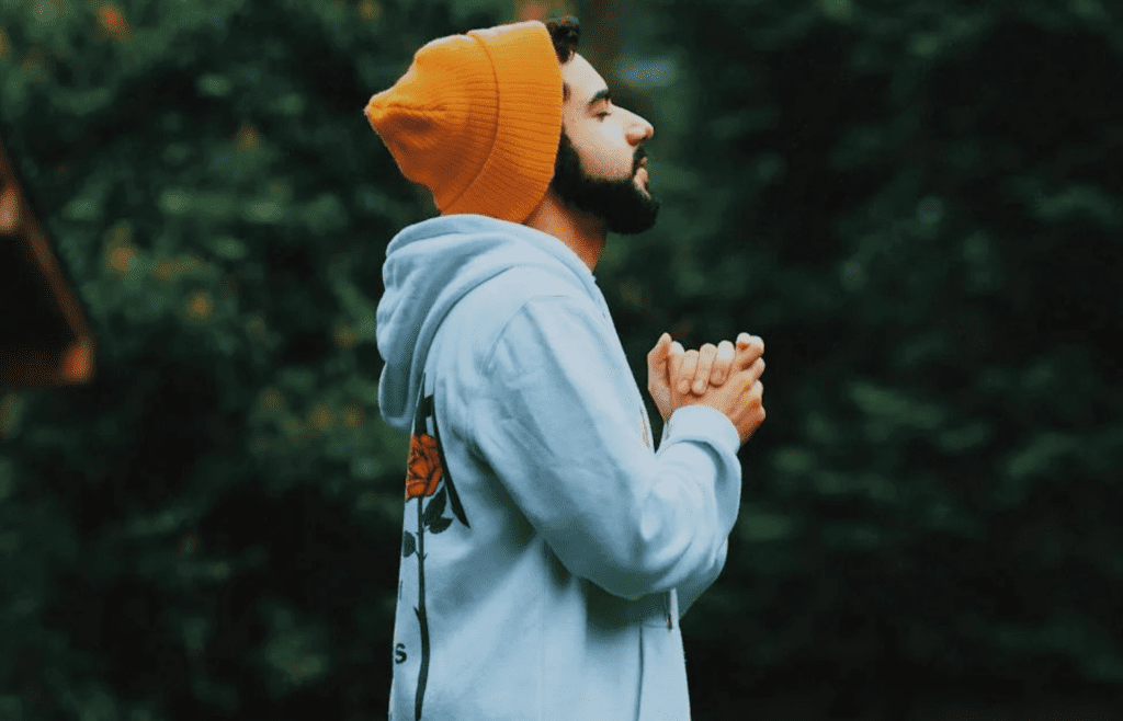 A person pausing with eyes closed and deep breath