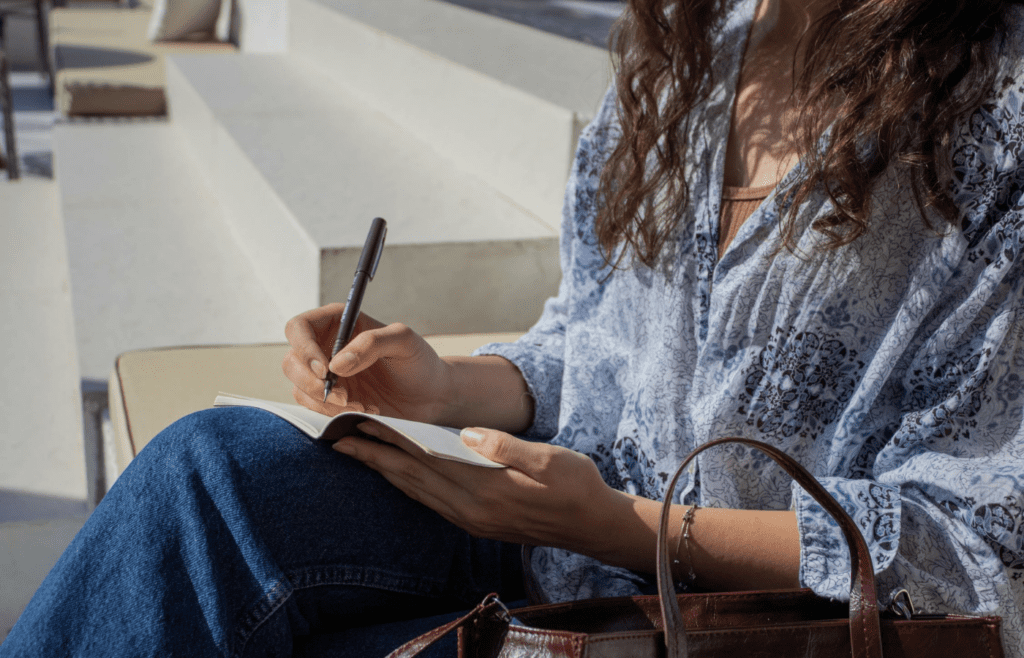 A person journaling or planning next steps