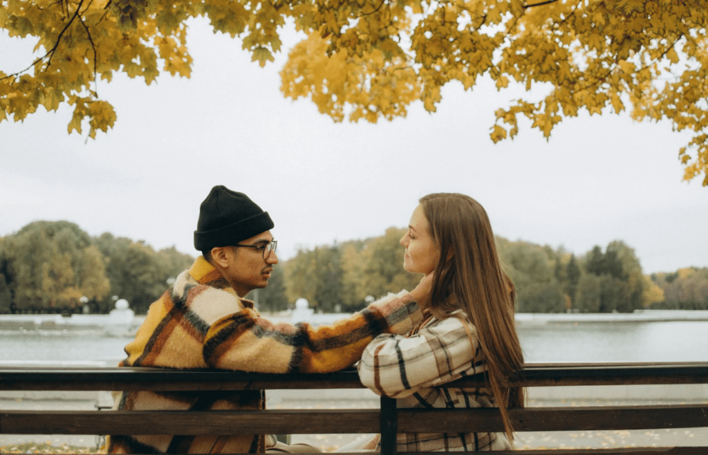 A couple sitting quietly at the beach or on a park bench