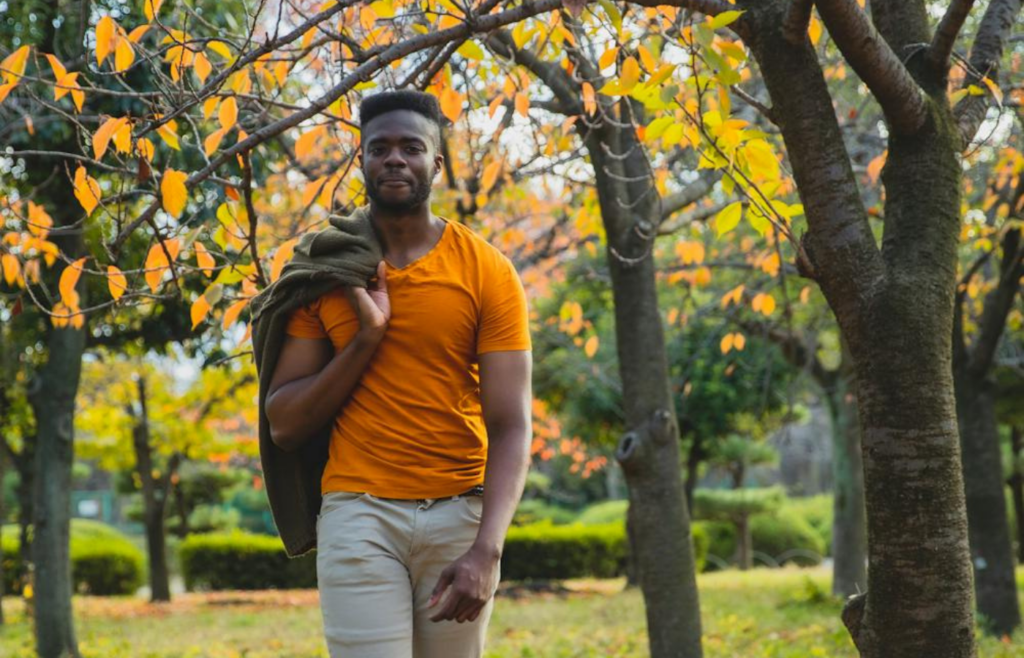 A person enjoying a walk alone through a park