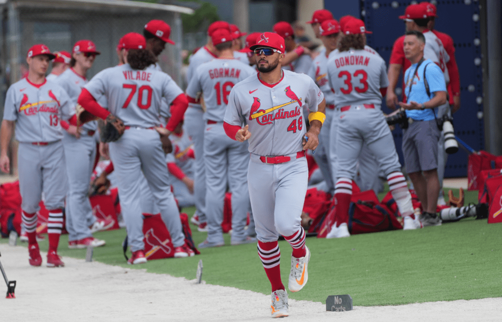 Feb 17, 2025; Jupiter, FL, USA; St. Louis Cardinals catcher Ivan Herrera (48) heads to a workout group as the rest of his team gathers before spring training activities. Mandatory Credit: Jim Rassol-Imagn Images