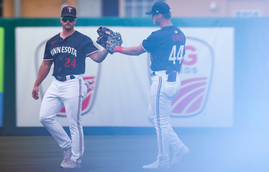 Minnesota Twins outfielders Caden Kendle (24) and Kyler Fedko (44) celebrates after the team defeated the Colorado Rockies in a spring training game at Lee Health Sports Complex in Fort Myers, Fla., on Tuesday, March 25, 2025.
