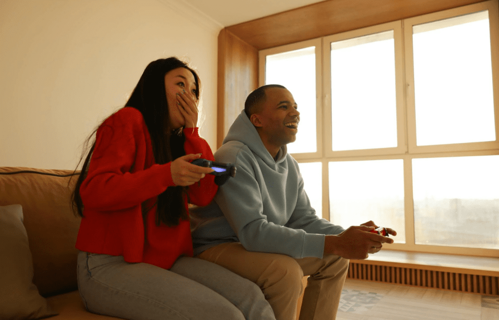 A couple laughing while doing different activities side by side