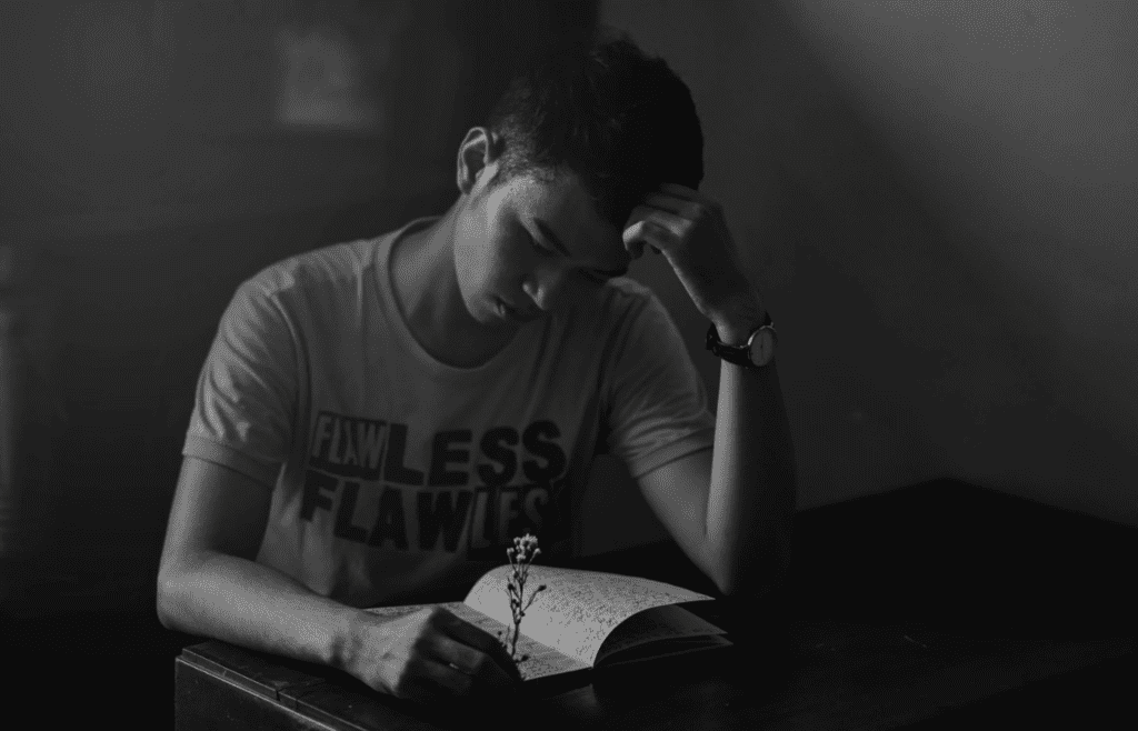 A person journaling or thinking quietly