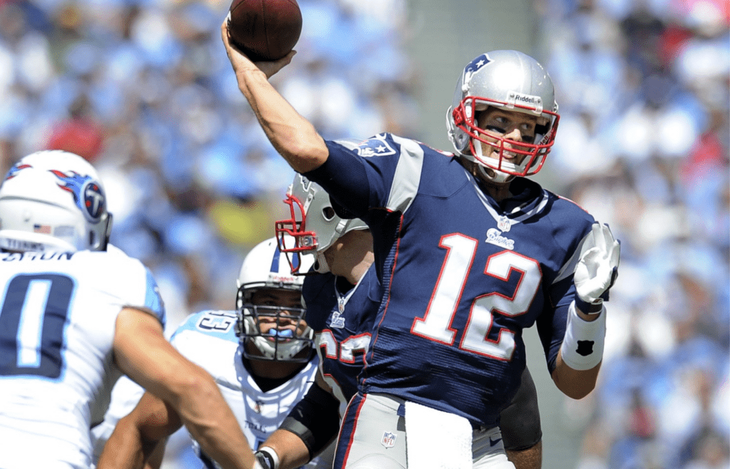 New England Patriots quarterback Tom Brady (12) throws a touchdown pass over the Tennessee Titans defense at LP Field in Nashville on Sept. 9, 2012. The Titans lost their home and season opener 34-13