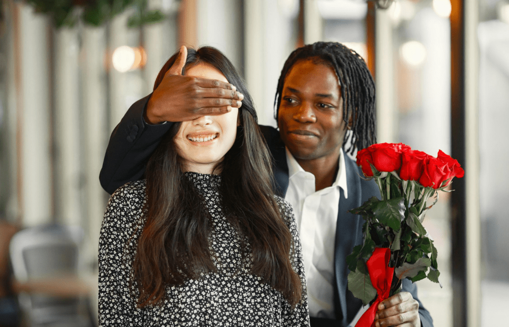 A person handing a small gift to their partner