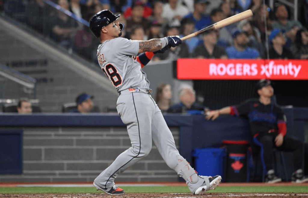 May 16, 2025; Toronto, Ontario, CAN; Detroit Tigers center fielder Javier Baez (28) hits a solo home run against the Toronto Blue Jays in the eighth inning at Rogers Centre. Mandatory Credit: Dan Hamilton-Imagn Images