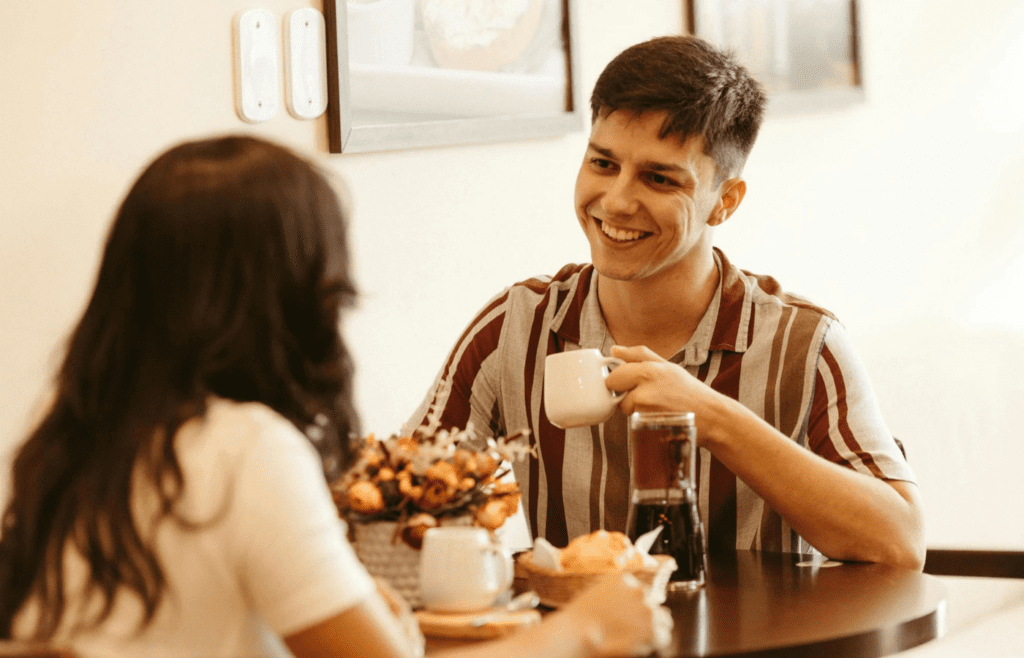 A couple chatting in a cozy coffee shop