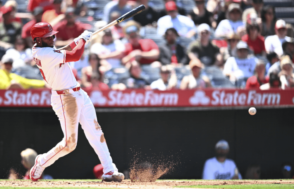 May 25, 2025; Anaheim, California, USA; Los Angeles Angels shortstop Tim Anderson (77) forced out at first base against the Miami Marlins during the sixth inning at Angel Stadium. Mandatory Credit: Jonathan Hui-Imagn Images