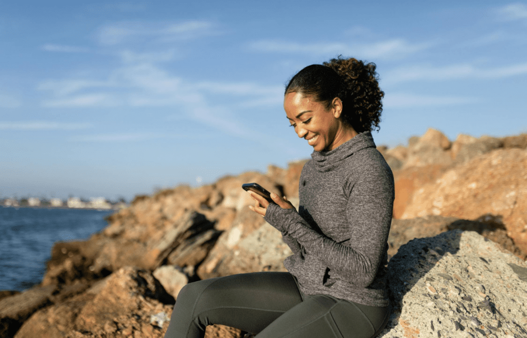 A person smiling while texting