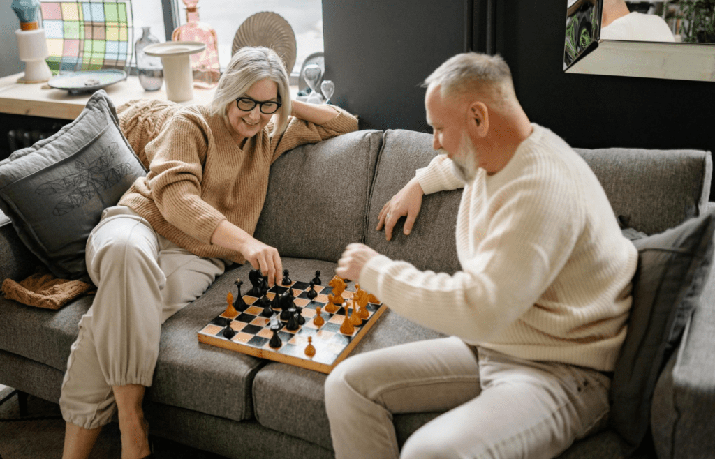 A couple playing a board game or sitting outside together