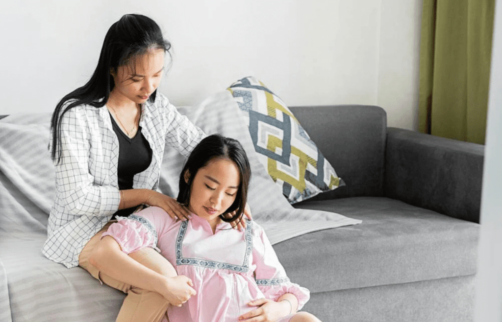 A partner giving the other a shoulder massage at home