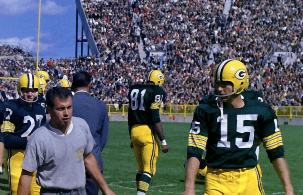Green Bay Packers quarterback Zeke Bratkowski (12), Jim Taylor (31), Bart Starr (15) and teammates walk onto Lambeau Field for their game against the Los Angeles Rams on Sept, 25, 1966, in Green Bay, Wis. The Packers defeated the Rams 24-13. Gpg Packers Archive Series 11072022 0035