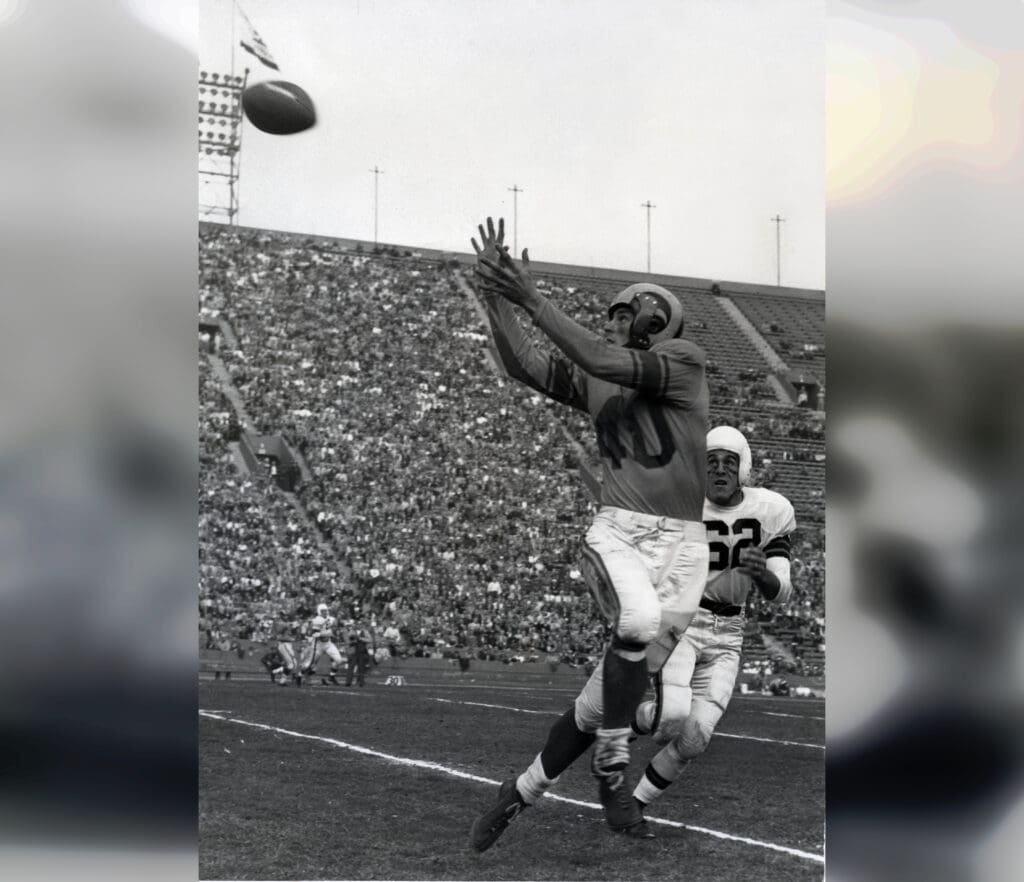 Dec 23, 1951; Los Angeles, CA, USA; FILE PHOTO; Los Angeles Rams receiver Elroy Hirsch (40) catches a pass in front of Cleveland Browns defensive back Cliff Lewis (62) at the Los Angeles Memorial Coliseum in the 1951 NFL Championship Game. The Rams defeated the Browns 24-17. Mandatory Credit: Darryl Norenberg-Imagn Images