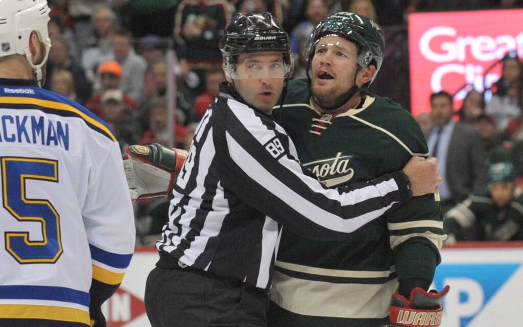 Apr 26, 2015; Saint Paul, MN, USA; Minnesota Wild forward Matt Cooke (24) exchanges words with Saint Louis Blues defenseman Barret Jackman (5) as each of them are given a penalty during the second period in game six of the first round of the 2015 Stanley Cup Playoffs at Xcel Energy Center. Mandatory Credit: Marilyn Indahl-Imagn Images