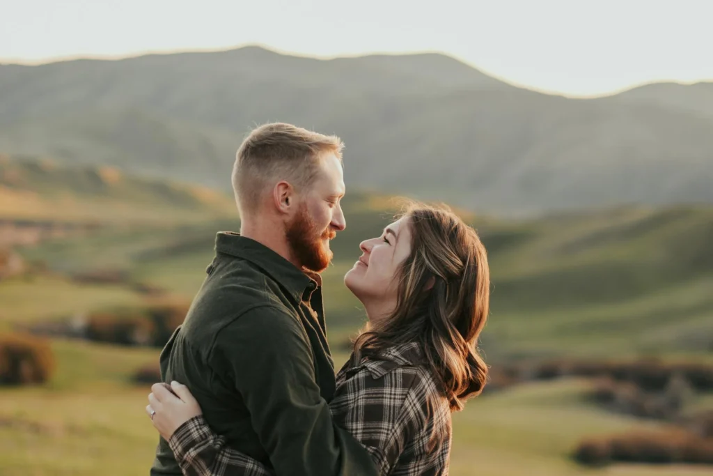 A couple smiling while looking into each other’s eyes