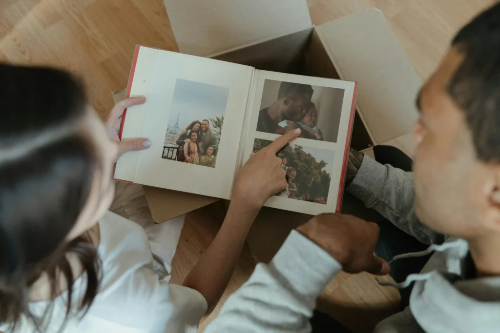 A couple flipping through old photo albums