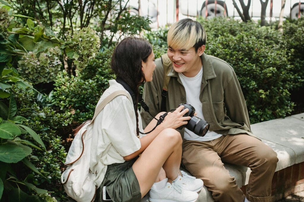 A couple deep in conversation on a park bench