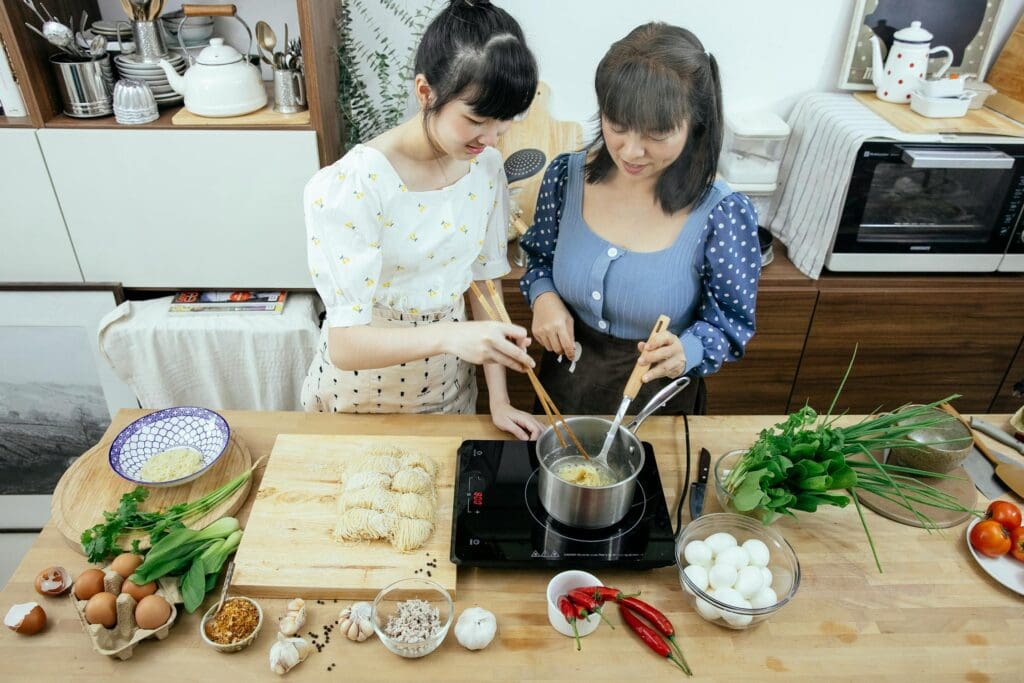 A traveler learning to cook local dishes with a chef