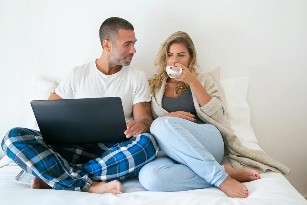 A couple looking distant in bed