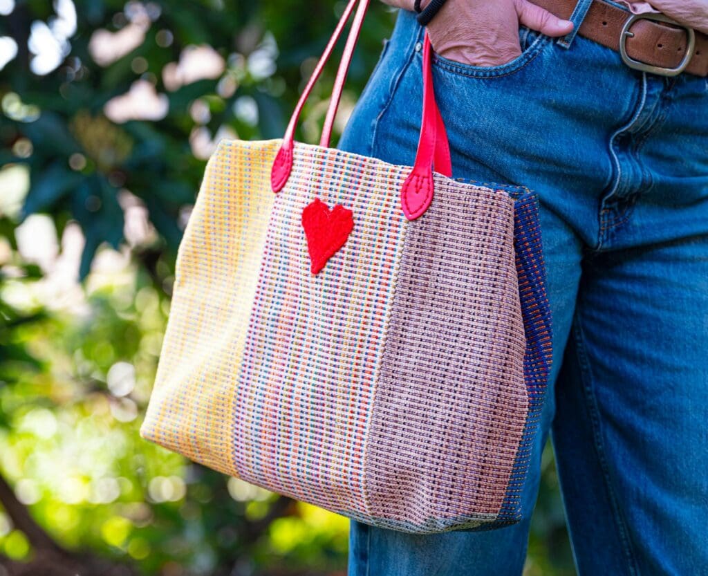 A foldable tote bag packed in a carry-on