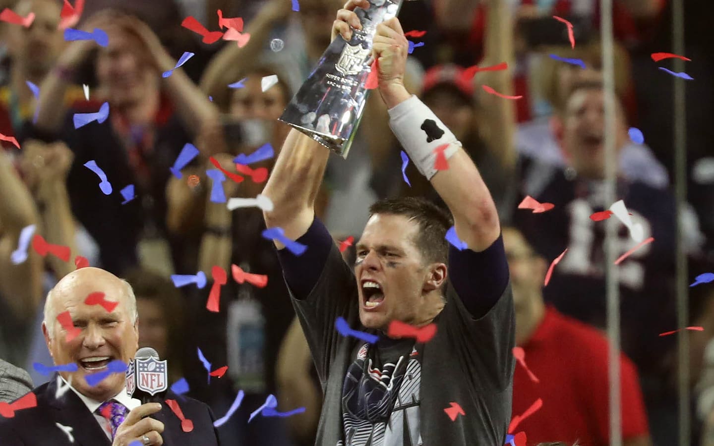 Super Bowl 51: New England Patriots quarterback Tom Brady celebrates with the Vince Lombardi Trophy on the podium after defeating the Atlanta Falcons 34-28 in overtime in Super Bowl LI at NRG Stadium on Feb 5, 2017.