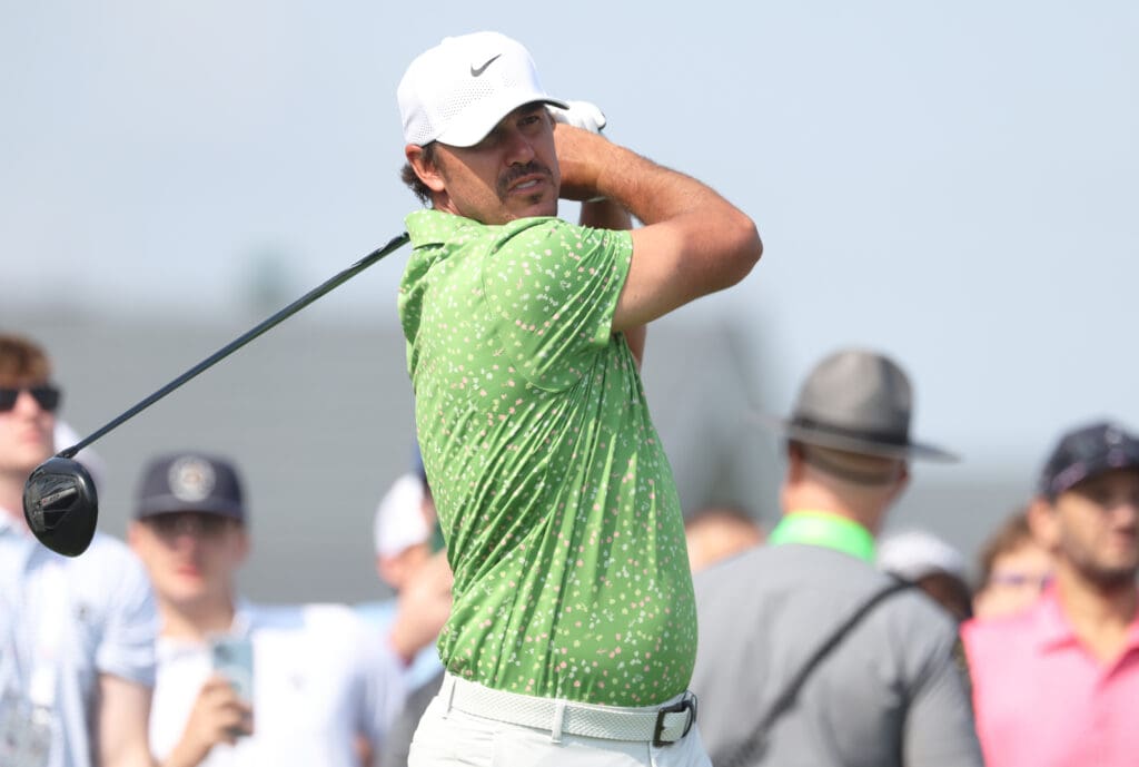 Jun 10, 2025; Oakmont, Pennsylvania, USA; Brooks Koepka hits his tee shot on the 12th hole during a practice round for the U.S. Open golf tournament at Oakmont Country Club.