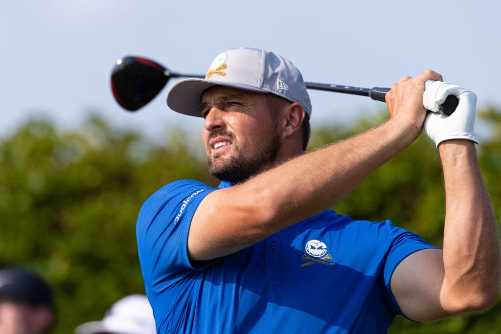 Jun 10, 2025; Oakmont, Pennsylvania, USA; Bryson DeChambeau plays his shot from the ninth tee during a practice round for the U.S. Open golf tournament at Oakmont Country Club.