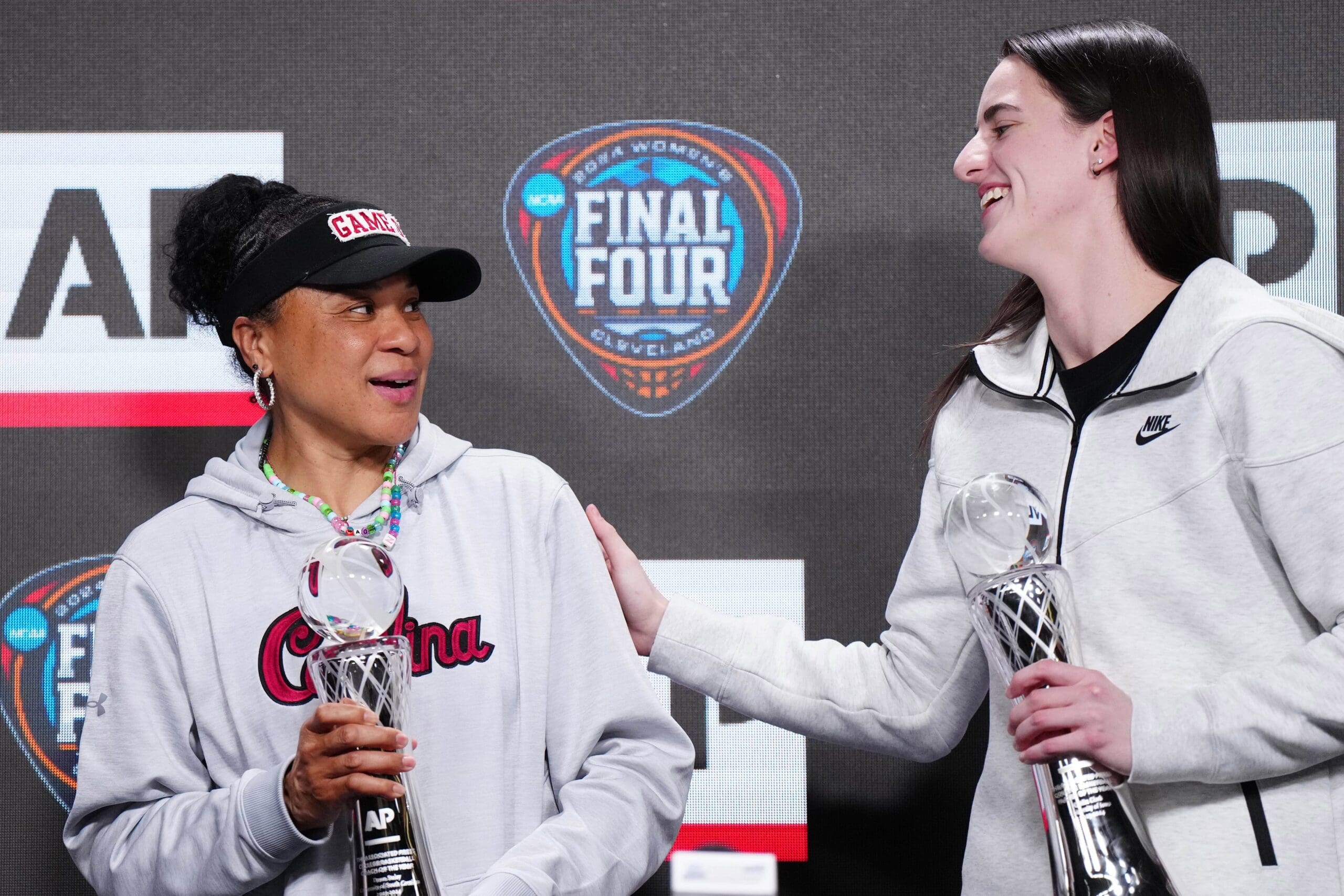 Apr 4, 2024; Cleveland, OH, USA; South Carolina Gamecocks coach Dawn Staley (left) and Iowa Hawkeyes guard Caitlin Clark pose react after being selected as the AP Coach and Player of the Year at a press conference at Rocket Mortgage FieldHouse. Mandatory Credit: Kirby Lee-USA TODAY Sports
