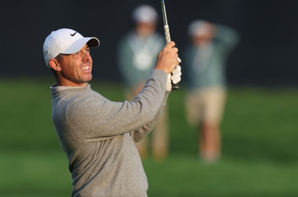 Jun 11, 2025; Oakmont, Pennsylvania, USA; Rory McIlroy watches his shot from the fairway on hole two during a practice round for the U.S. Open golf tournament at Oakmont Country Club.